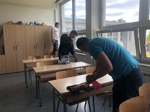 Students’ fathers cleaning a classroom